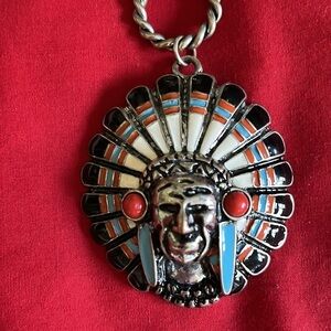Native American long necklace with Native American head and two feathers.